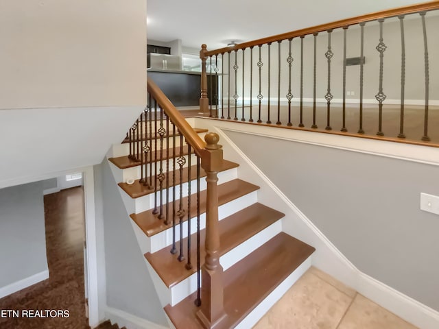 staircase featuring tile patterned floors