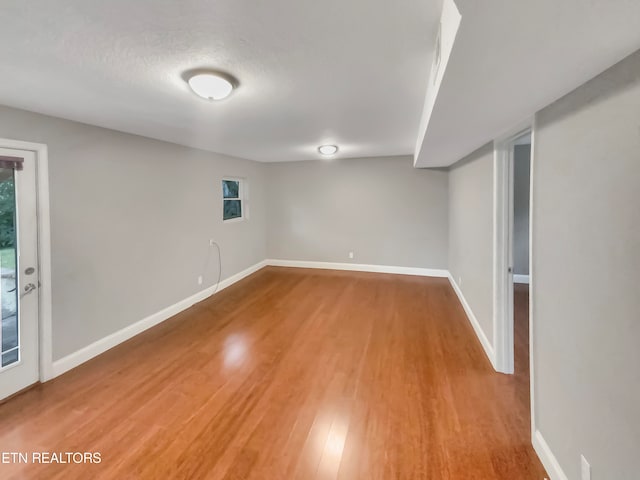 basement with wood-type flooring and a textured ceiling