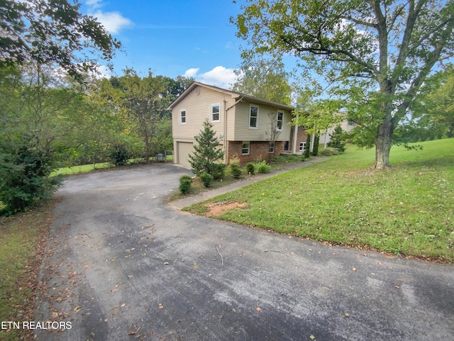 view of property exterior with a garage and a yard