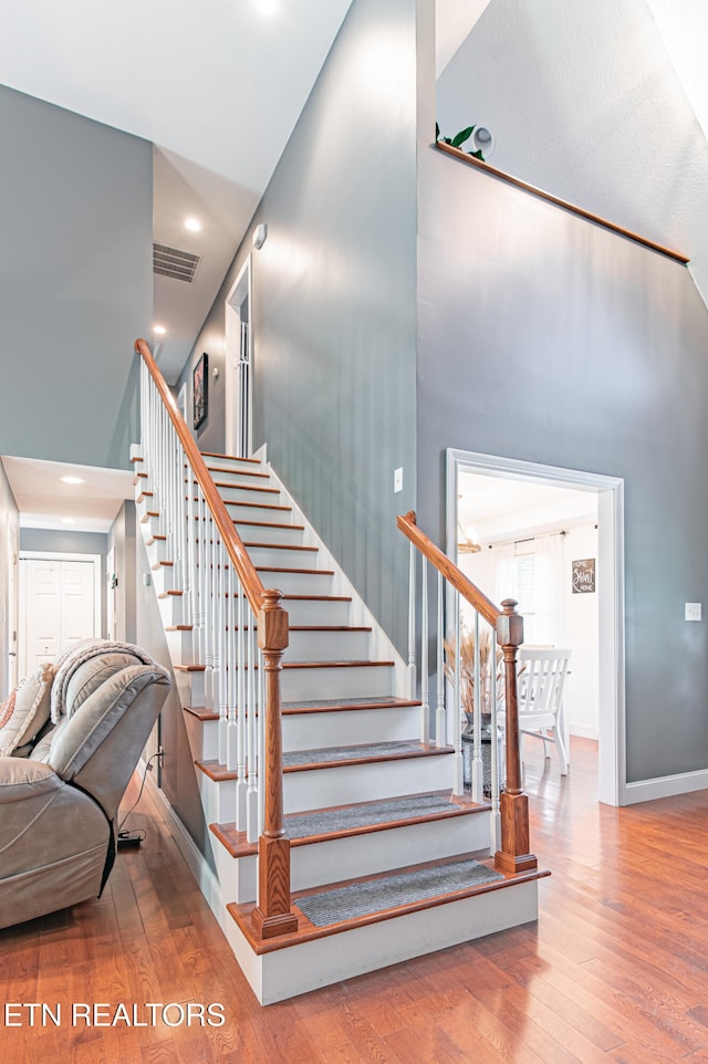 stairway with hardwood / wood-style floors