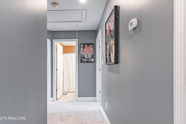 hallway featuring light colored carpet