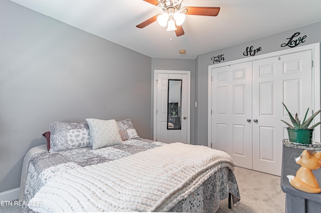 bedroom with light carpet, ceiling fan, and a closet