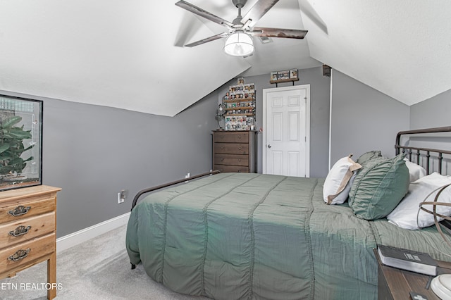 carpeted bedroom featuring lofted ceiling and ceiling fan