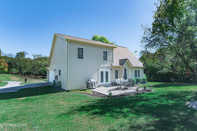 rear view of house featuring a patio and a lawn