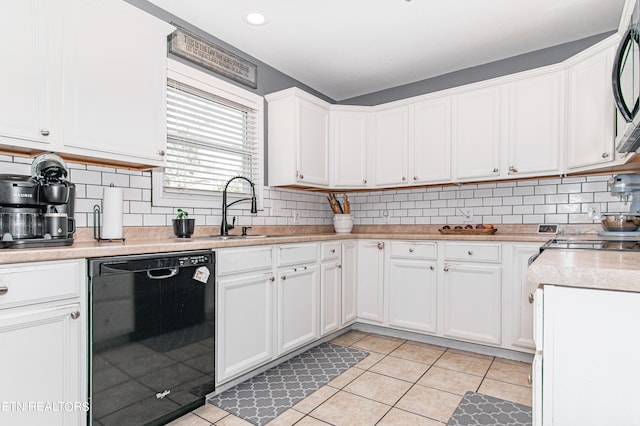 kitchen featuring white cabinetry, sink, light tile patterned floors, and dishwasher