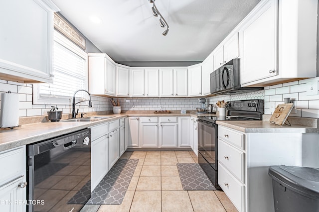 kitchen featuring sink, white cabinetry, decorative backsplash, and black appliances