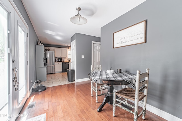 dining area featuring a wealth of natural light and light wood-type flooring