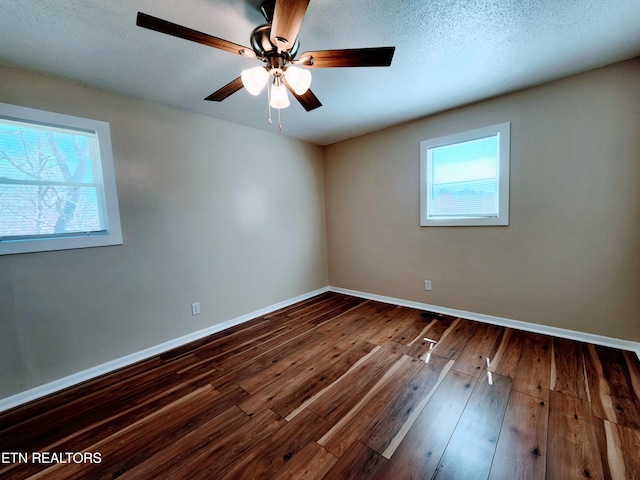 empty room featuring ceiling fan, hardwood / wood-style flooring, and a textured ceiling