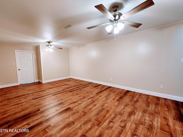 empty room featuring ceiling fan and light hardwood / wood-style floors