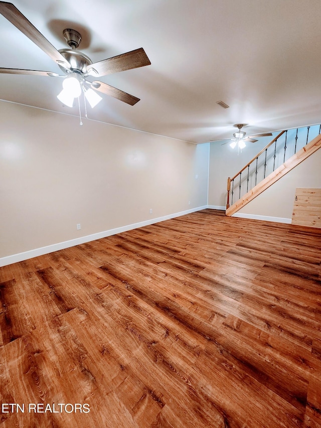 unfurnished room with hardwood / wood-style flooring and ceiling fan