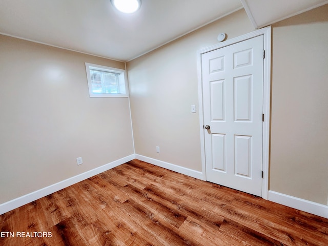 spare room featuring wood-type flooring