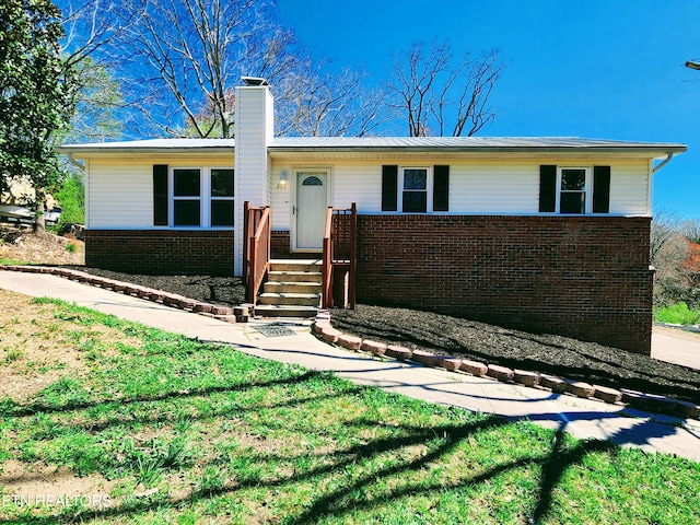 ranch-style home with a front lawn