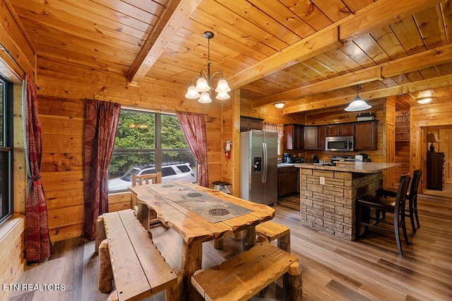 dining area with beamed ceiling, wooden walls, and light wood-type flooring