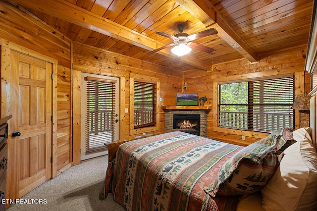 bedroom with wooden walls, ceiling fan, wooden ceiling, access to exterior, and beam ceiling