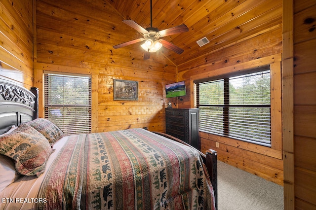 bedroom featuring lofted ceiling, carpet floors, wooden walls, and ceiling fan