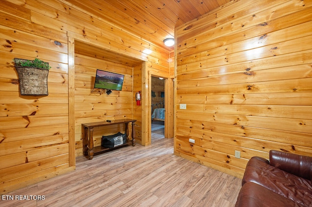 living room with wood walls, wood ceiling, and hardwood / wood-style flooring