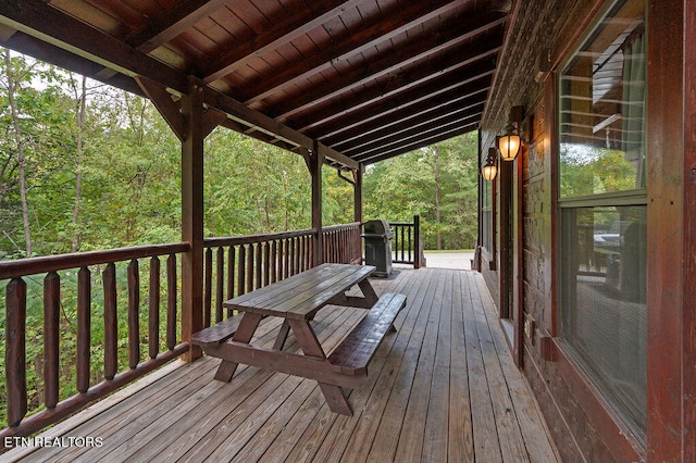 wooden deck with a grill