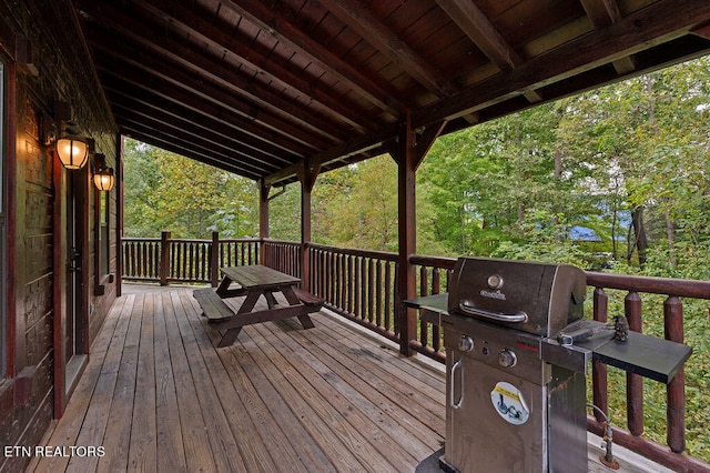 wooden deck with a grill