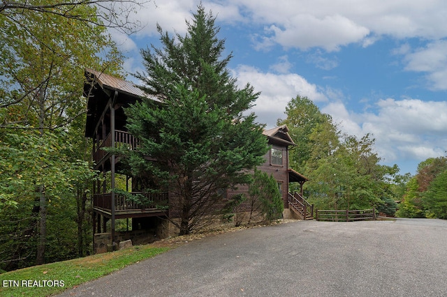 view of side of property with a wooden deck