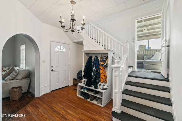 foyer featuring ornamental molding and dark wood-type flooring