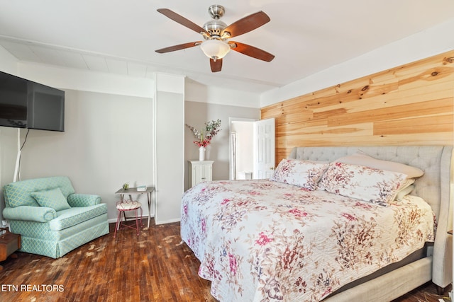 bedroom featuring ceiling fan and dark wood-type flooring