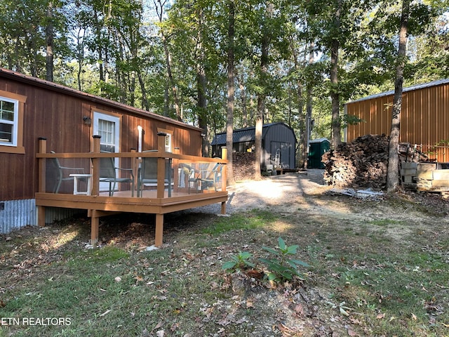 view of yard featuring a storage unit and a deck