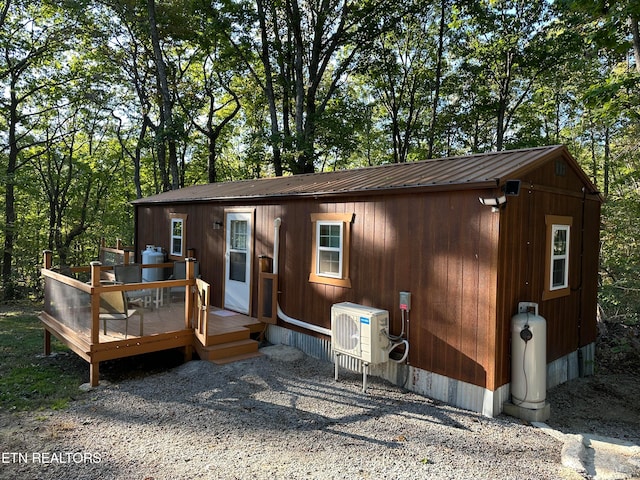 exterior space featuring ac unit and a wooden deck