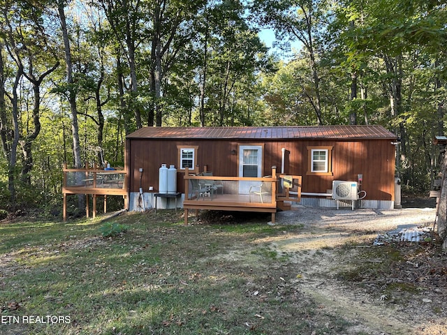 back of property featuring ac unit and a deck