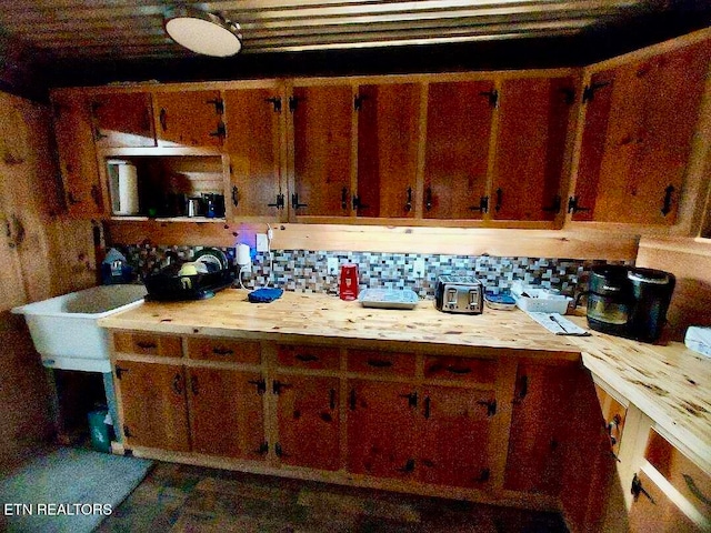 kitchen featuring butcher block countertops and backsplash