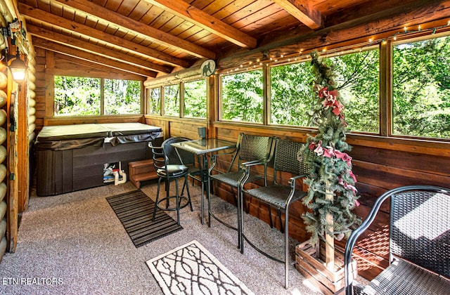 sunroom / solarium with a jacuzzi, wood ceiling, lofted ceiling with beams, and a wealth of natural light