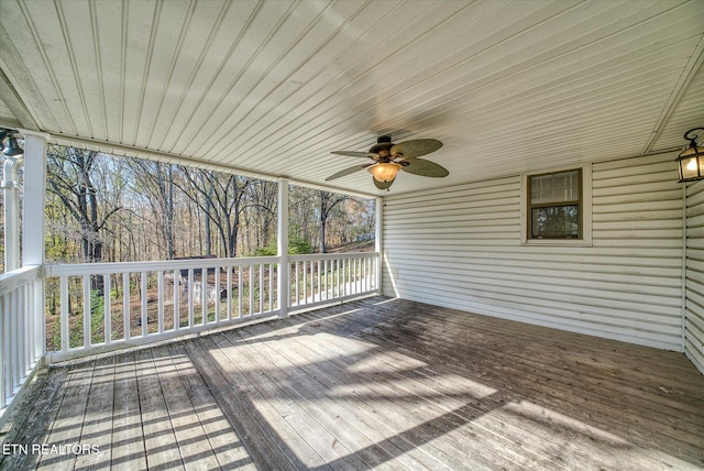 wooden deck featuring ceiling fan