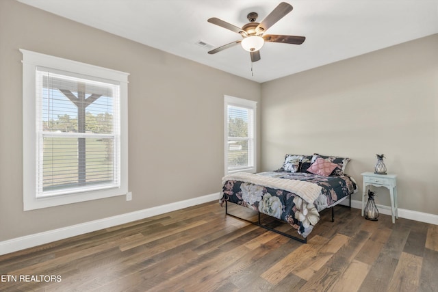 bedroom featuring ceiling fan and dark wood-type flooring