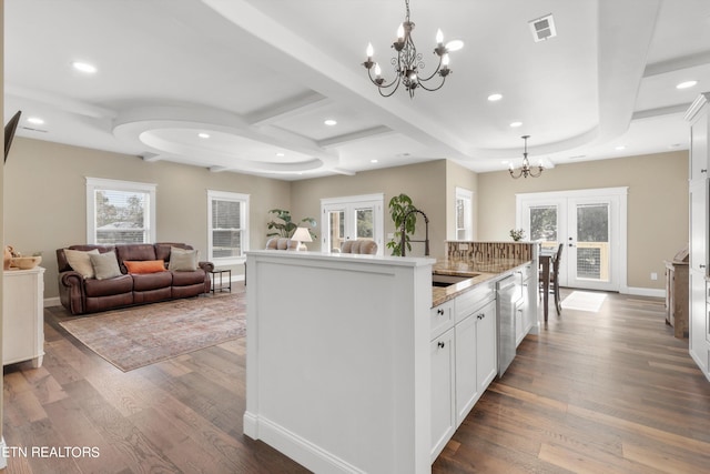 kitchen featuring french doors, decorative light fixtures, hardwood / wood-style flooring, and a healthy amount of sunlight