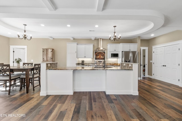 kitchen featuring pendant lighting, appliances with stainless steel finishes, dark hardwood / wood-style floors, and white cabinetry