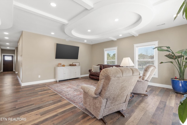 living room with beam ceiling and dark hardwood / wood-style flooring