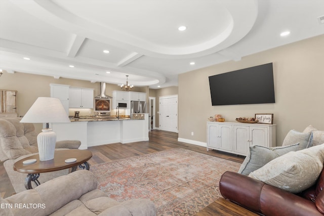 living room featuring beamed ceiling and wood-type flooring