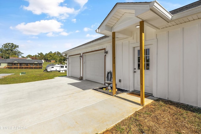 view of side of property featuring a garage and a yard