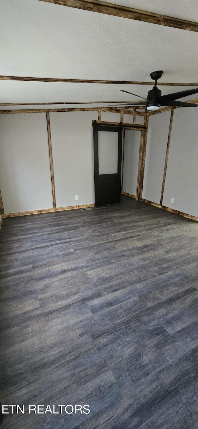 interior space with a textured ceiling and dark hardwood / wood-style floors