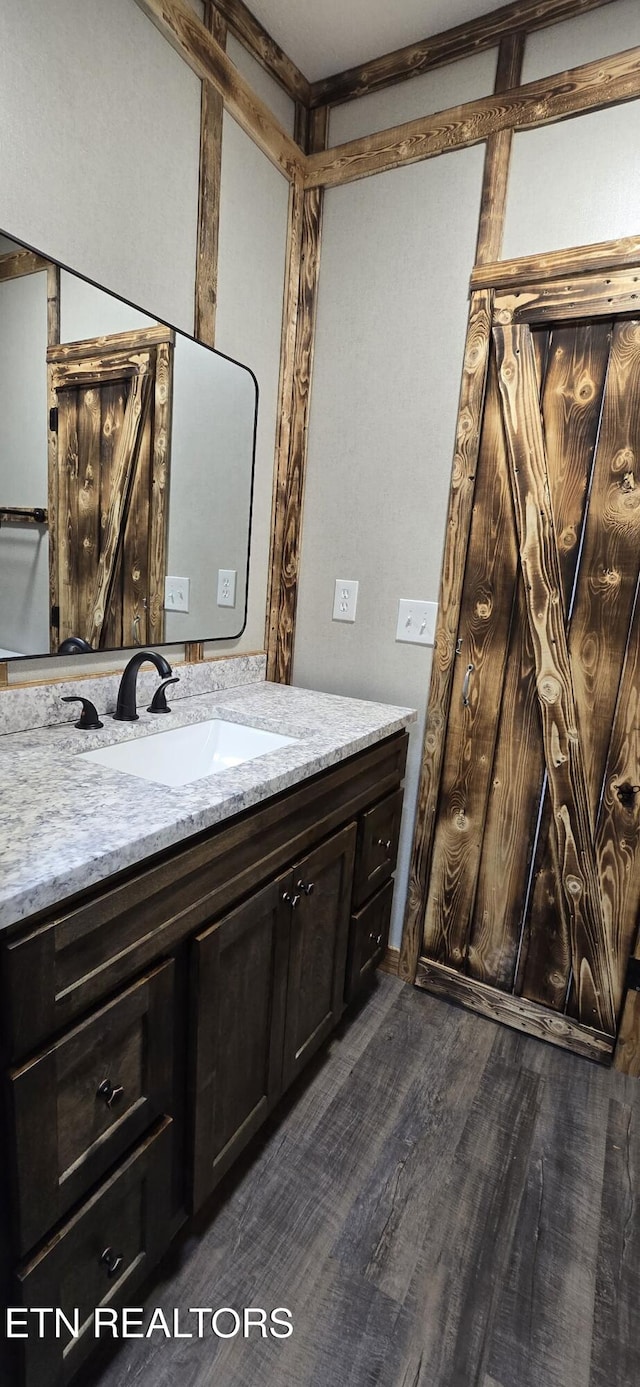 bathroom with vanity and hardwood / wood-style floors