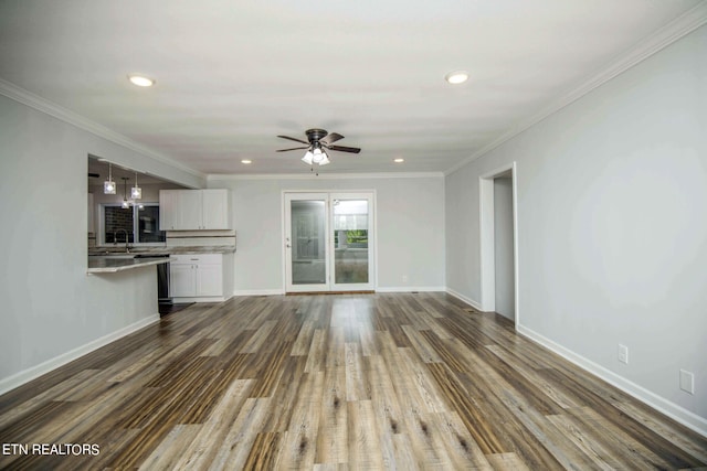 unfurnished living room featuring wood-type flooring, ceiling fan, ornamental molding, and sink