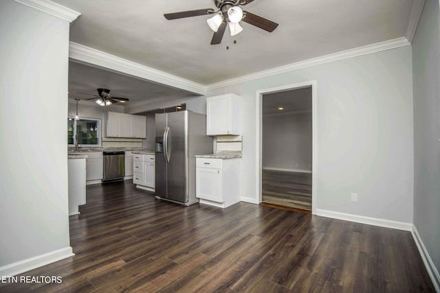 kitchen featuring white cabinetry, dark wood-type flooring, appliances with stainless steel finishes, and ornamental molding