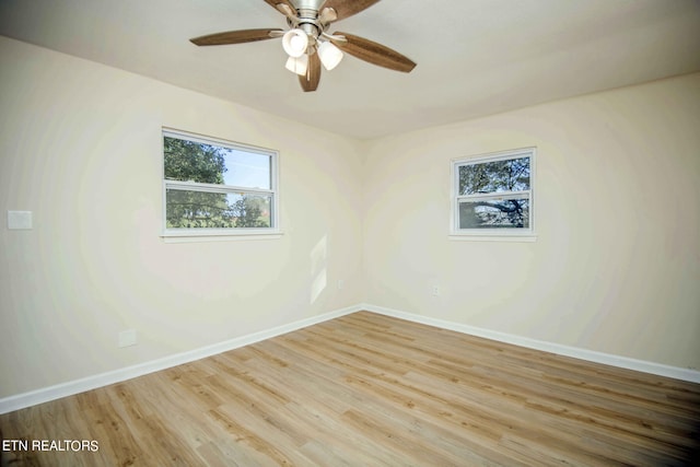 empty room with ceiling fan and light hardwood / wood-style floors