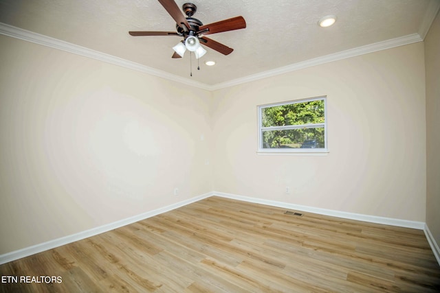 spare room with a textured ceiling, light wood-type flooring, ceiling fan, and ornamental molding