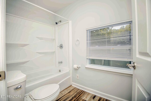 bathroom with toilet, bathtub / shower combination, and hardwood / wood-style flooring