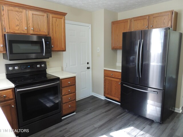 1432 Pheasants Glen Dr, Knoxville, TN 37923 - kitchen with light countertops, dark wood finished floors, stainless steel appliances, and brown cabinets