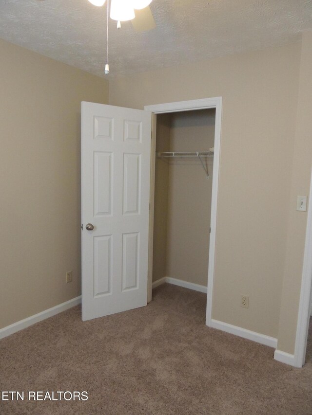 1432 Pheasants Glen Dr, Knoxville, TN 37923 - unfurnished bedroom with a textured ceiling, carpet floors, a closet, and baseboards