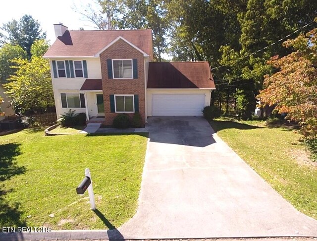 1432 Pheasants Glen Dr, Knoxville, TN 37923 - colonial house featuring a front yard, driveway, a chimney, and a garage