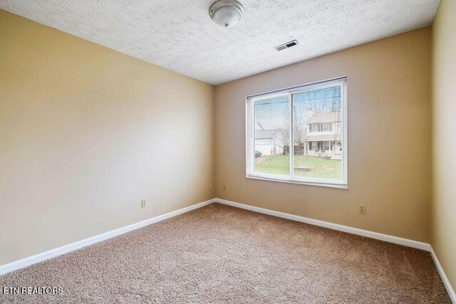1432 Pheasants Glen Dr, Knoxville, TN 37923 - empty room featuring a textured ceiling, carpet flooring, baseboards, and visible vents