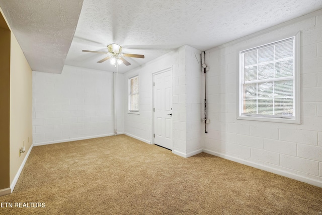 1432 Pheasants Glen Dr, Knoxville, TN 37923 - unfurnished bedroom featuring light colored carpet, a textured ceiling, a ceiling fan, baseboards, and concrete block wall
