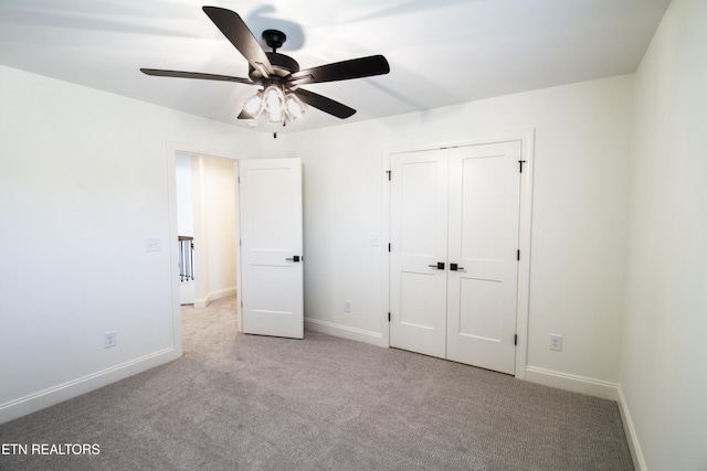 unfurnished bedroom featuring a closet, light carpet, and ceiling fan